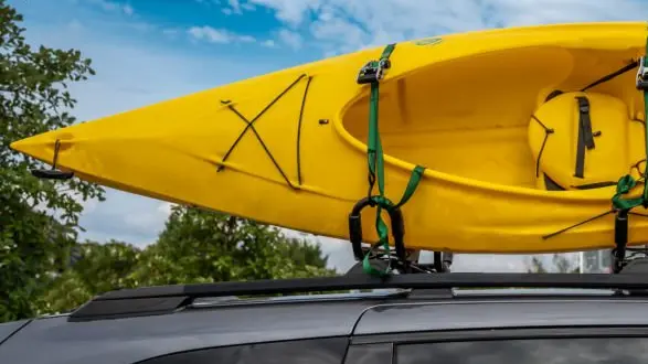 Roof mounted kayak on top of a van for transportation . High quality photo