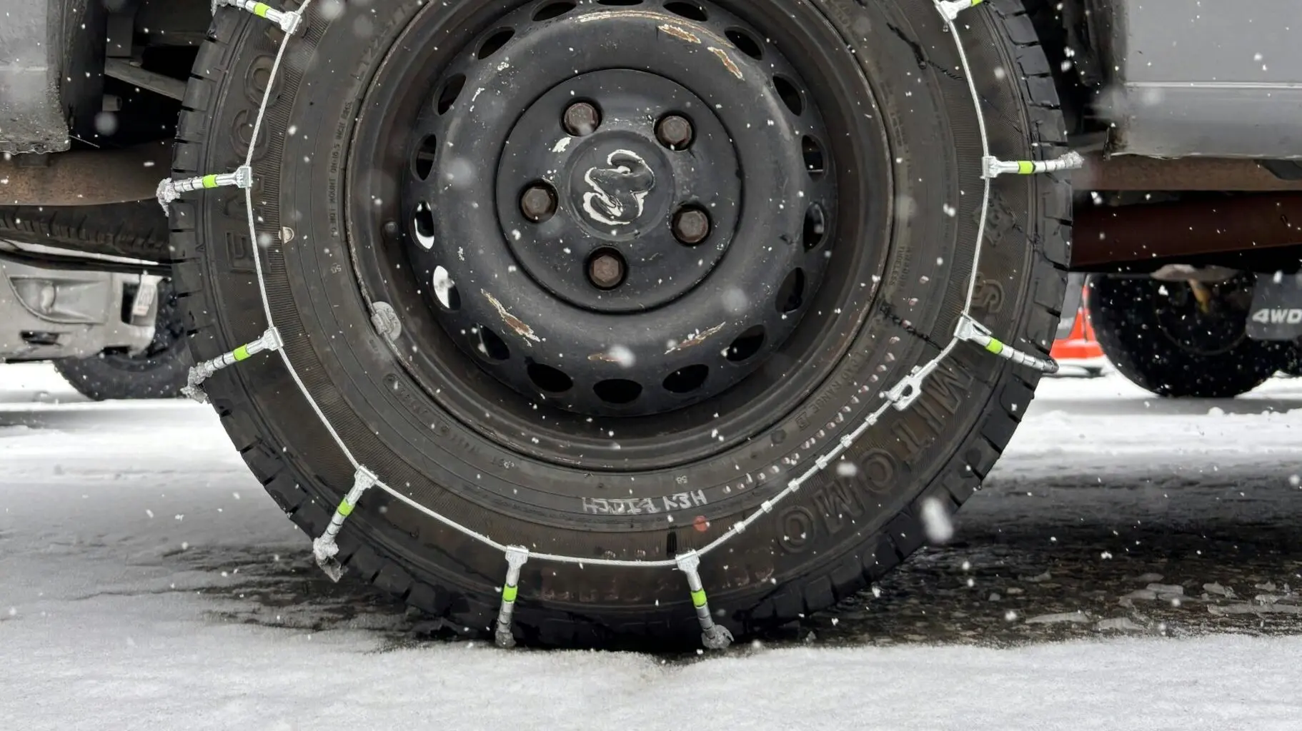 a 4x4 wheel with snow chains on it